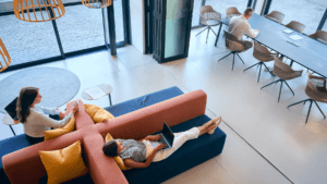 group of people lounging in a sunlit interior space