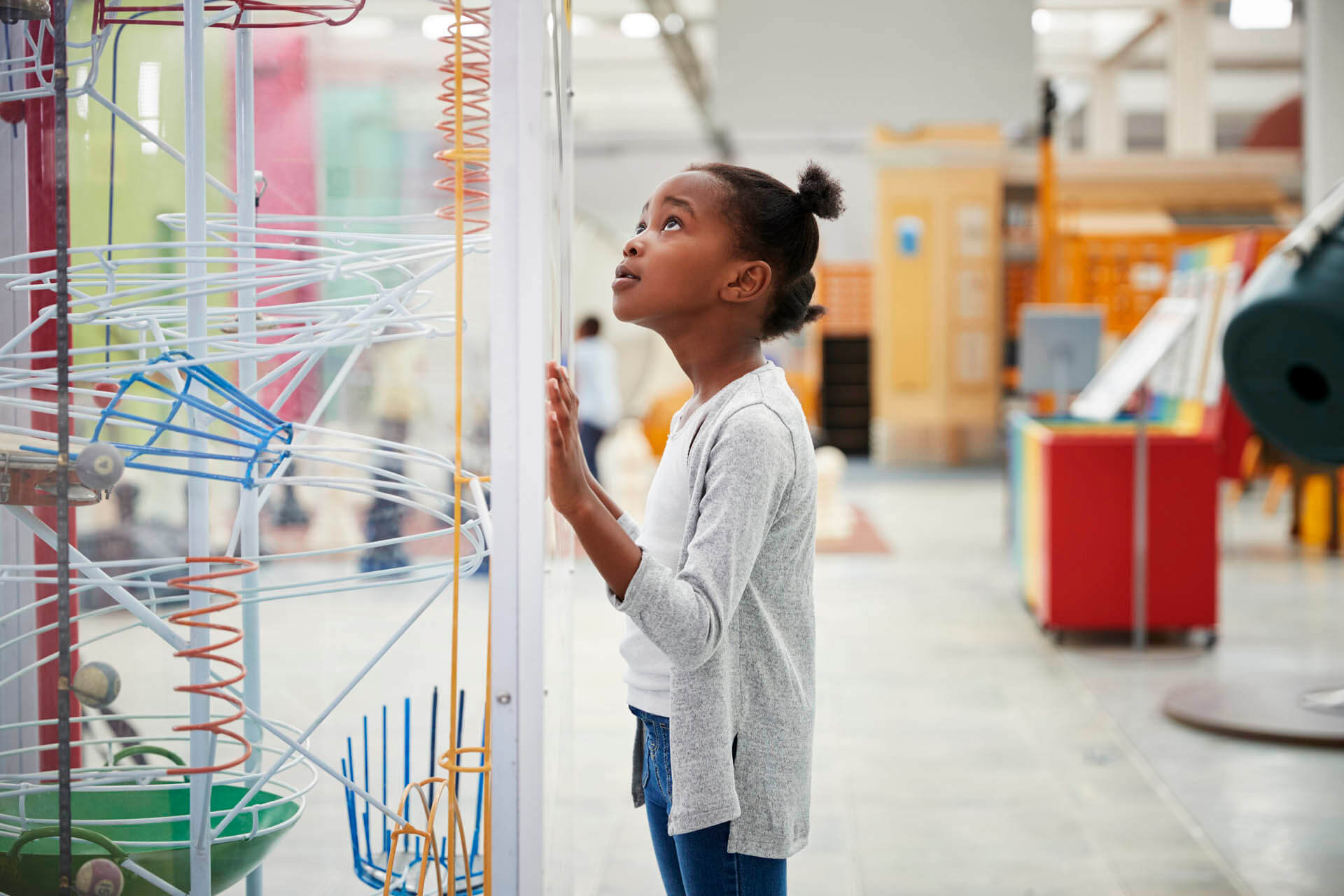 Young Black girl looking at a science exhibit, close up - 10 things to do in Orlando besides theme parks during Spring Break