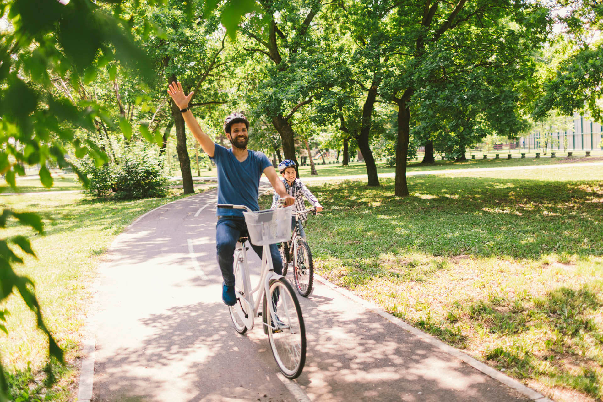 Father and son riding bicycle in the public park together - 10 things to do in Orlando besides theme parks during Spring Break